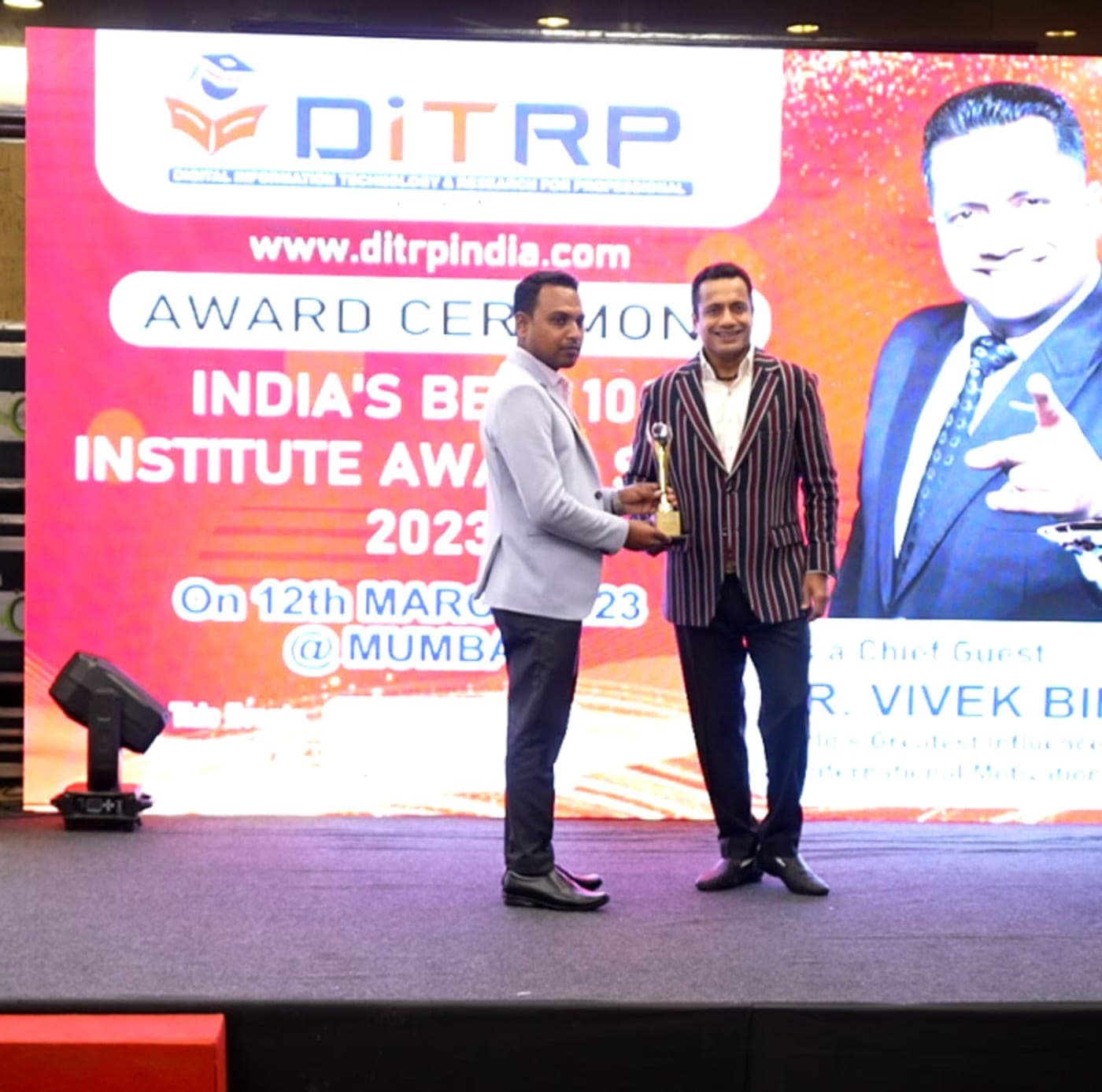 The India's Best 100 Institute Award ceremony on stage in Mumbai, 12 March 2023, with chief guest Dr. Vivek Bindra